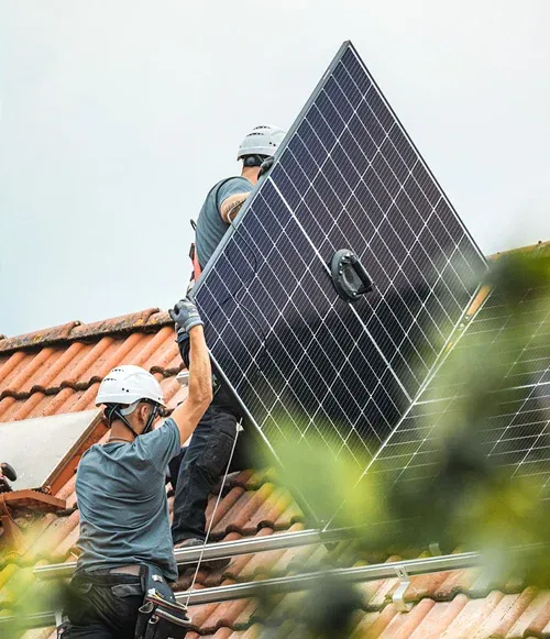 Enpal installers fitting solar panels on a roof