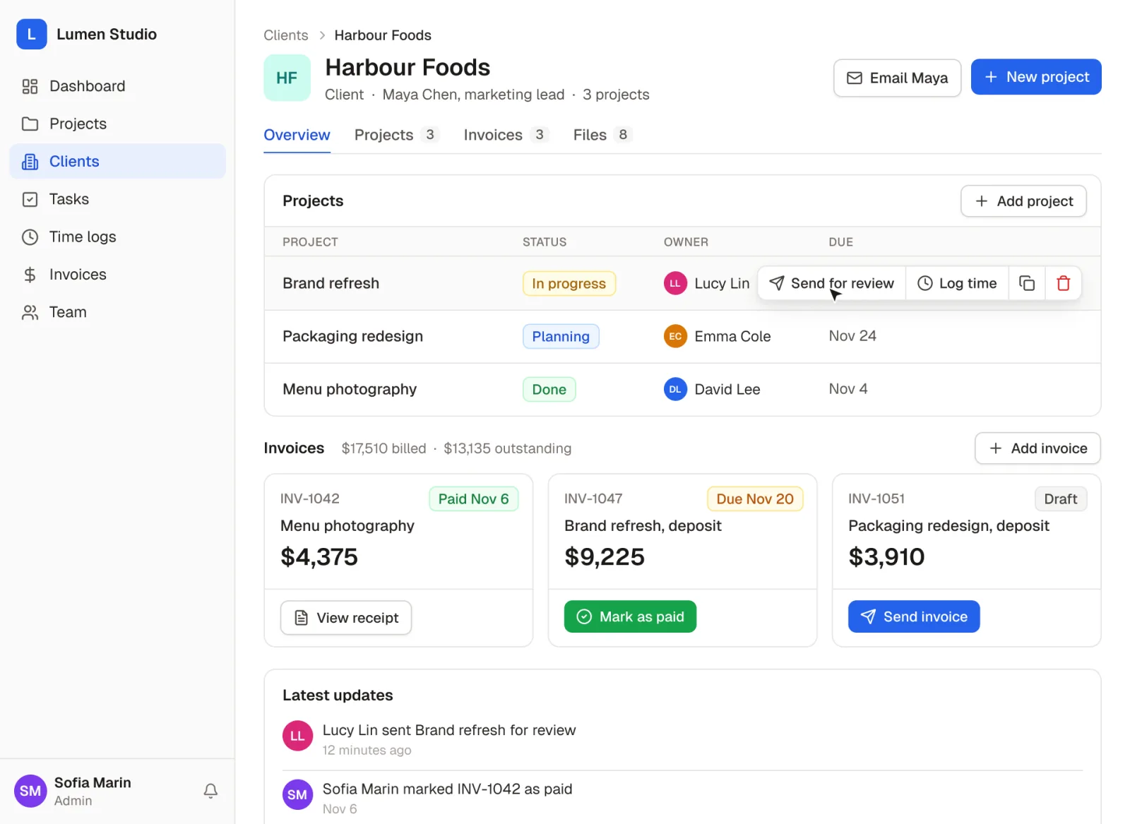 The Harbour Foods client page in a Noloco app with action buttons in three places: Email Maya and New project in the page header, a Send for review and Log time button group on a row of the related projects table, and Mark as paid and Send invoice buttons on the related invoice cards
